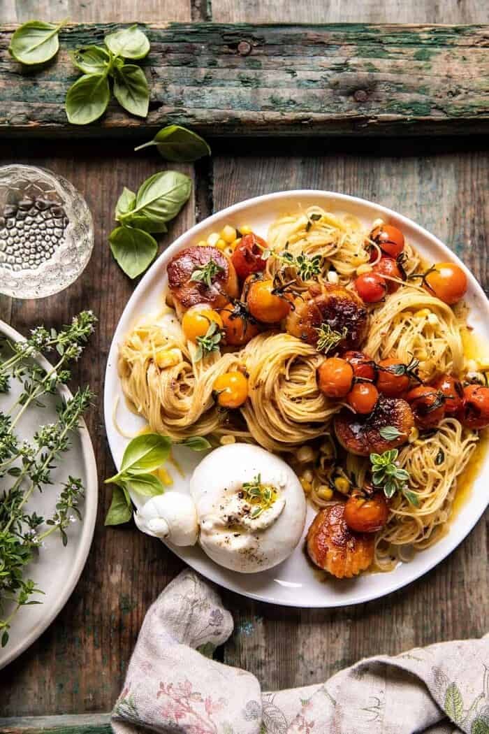 overhead photo of Browned Butter Scallops and Burst Tomato Basil Pasta with burrata 