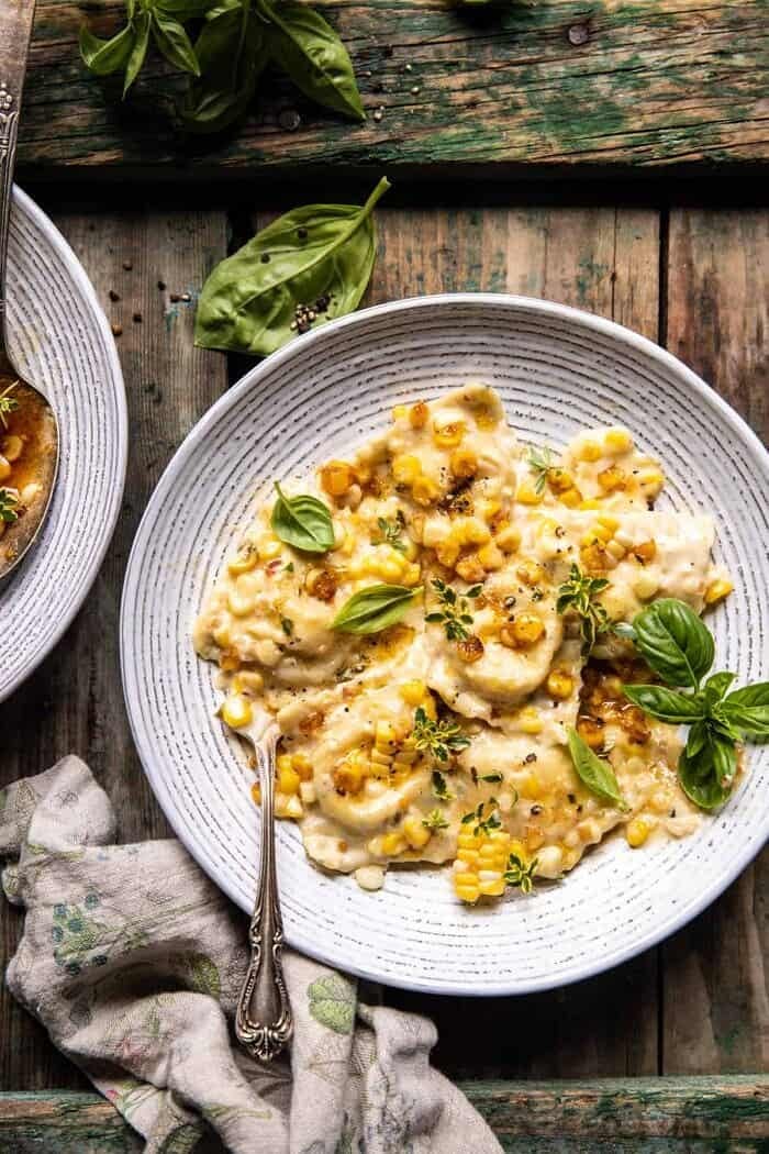 overhead photo of Browned Garlic Butter Creamed Corn Cheese Ravioli in pasta bowl with fork