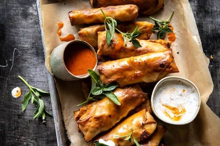 overhead horizontal photo of Baked Buffalo Chicken Egg Rolls with Cilantro Lime Ranch 
