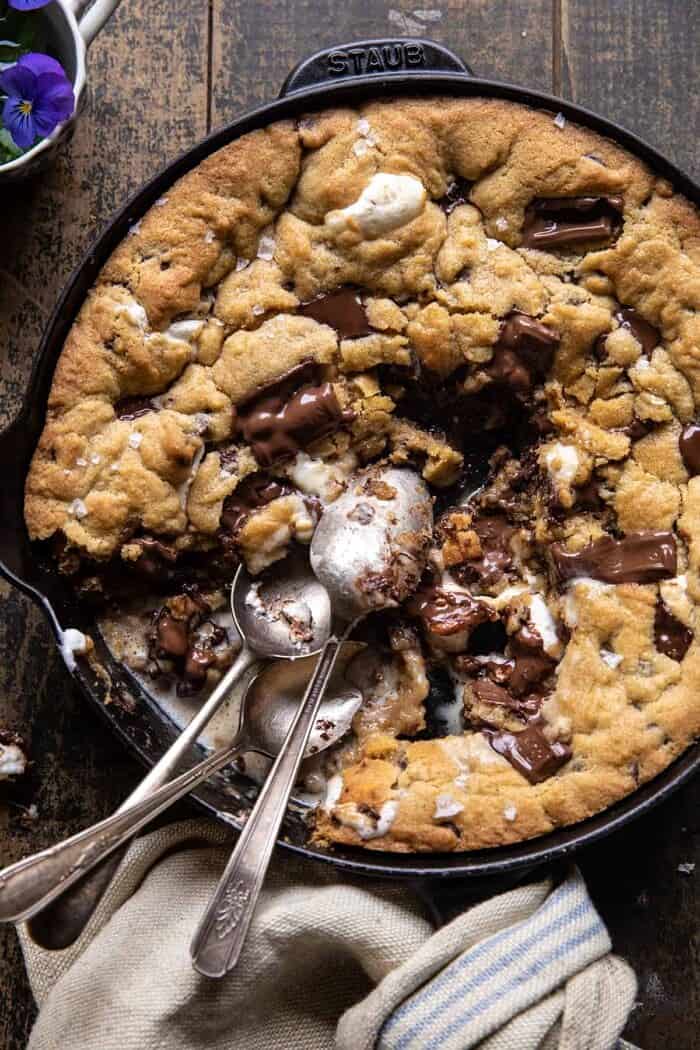 overhead photo of Giant S’mores Stuffed Chocolate Chip Skillet Cookie with spoons in skillet
