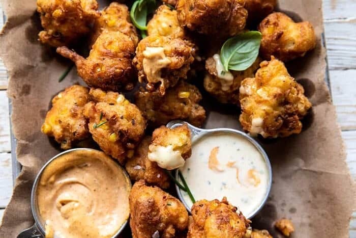 overhead horizontal photo of Jalapeño Cheddar Corn Fritters with Chipotle Aioli 