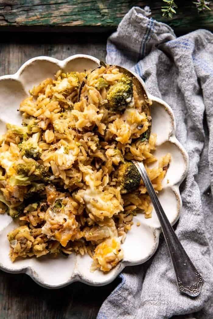 overhead photo of One Skillet Cheesy Broccoli Cheddar Orzo Bake on dinner plate with spoon