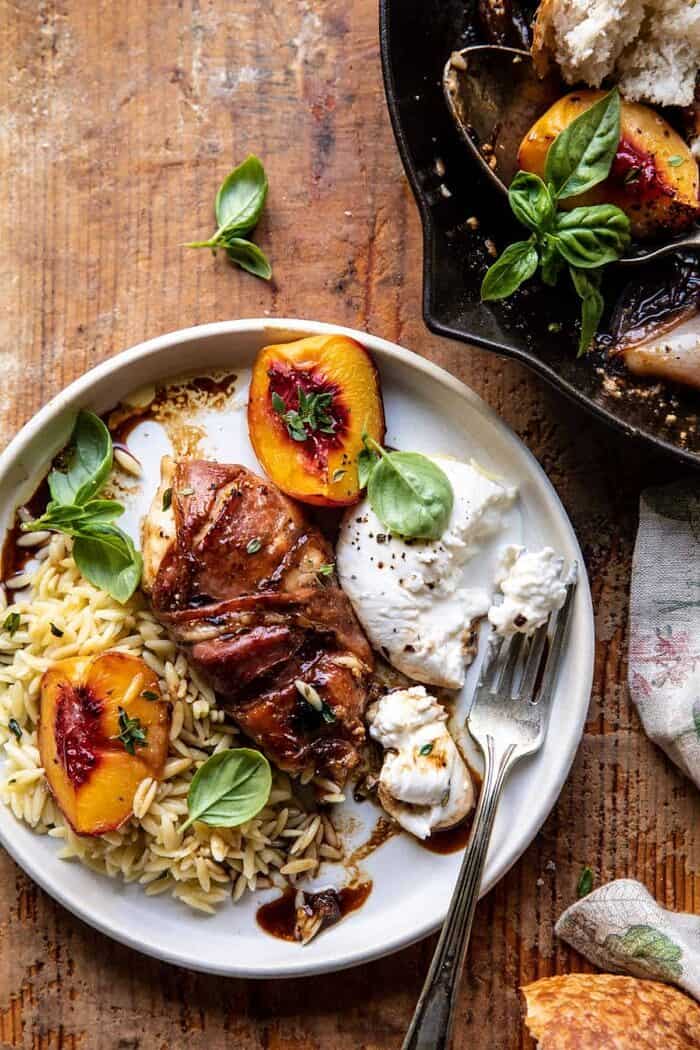 overhead photo of Prosciutto Balsamic Peach Chicken with Burrata and Basil on plate with orzo