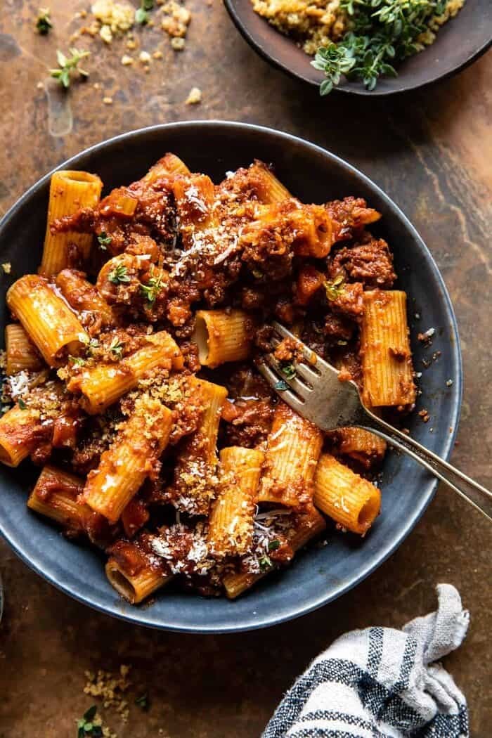 overhead photo of Slow Cooker Saucy Sunday Bolognese Pasta with fork in bowl 
