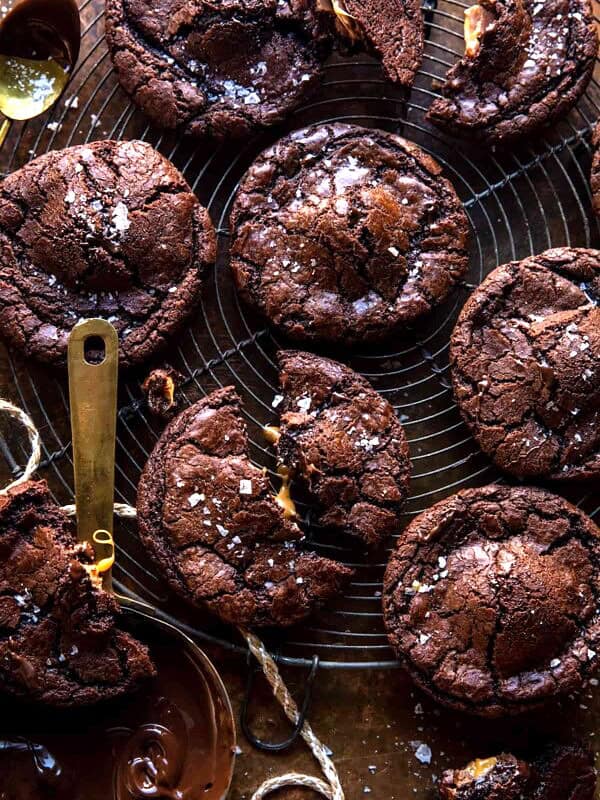 Crinkly Caramel Stuffed Brownie Cookies...for your Tuesday night pre-holiday cookie baking. Homemade crinkly brownie cookies, made with sweet milk chocolate, a touch of coffee, stuffed with gooey chocolate-covered caramels, then baked to perfection. Each cookie is finished with flaky sea salt for a cookie that's salty, sweet, and dangerously delicious. Each bite is crisp and crinkly on the top, but soft and gooey in the center. There’s nothing not to love about these sweet crinkly caramel stuffed brownie cookies.