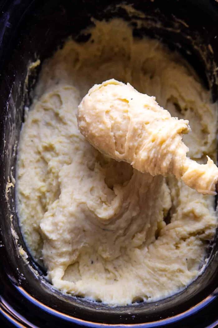 Slow Cooker Cheesy Garlic Herb Mashed Potatoes in the slow cooker pot 