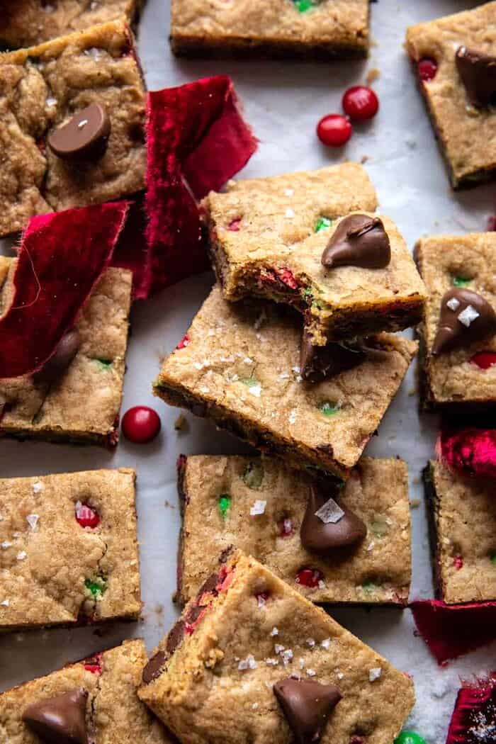 overhead close up photo of Brown Butter Christmas M&M Cookie Bar with bite taken out of bar
