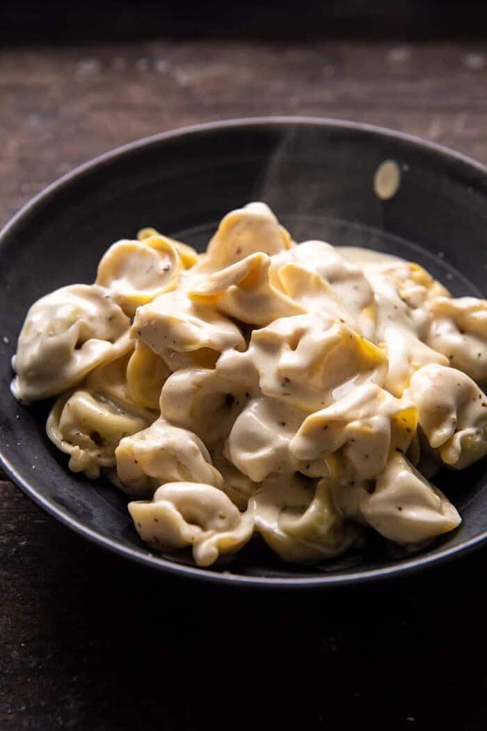 side angled photo of Creamy Bacon Tortellini with steam