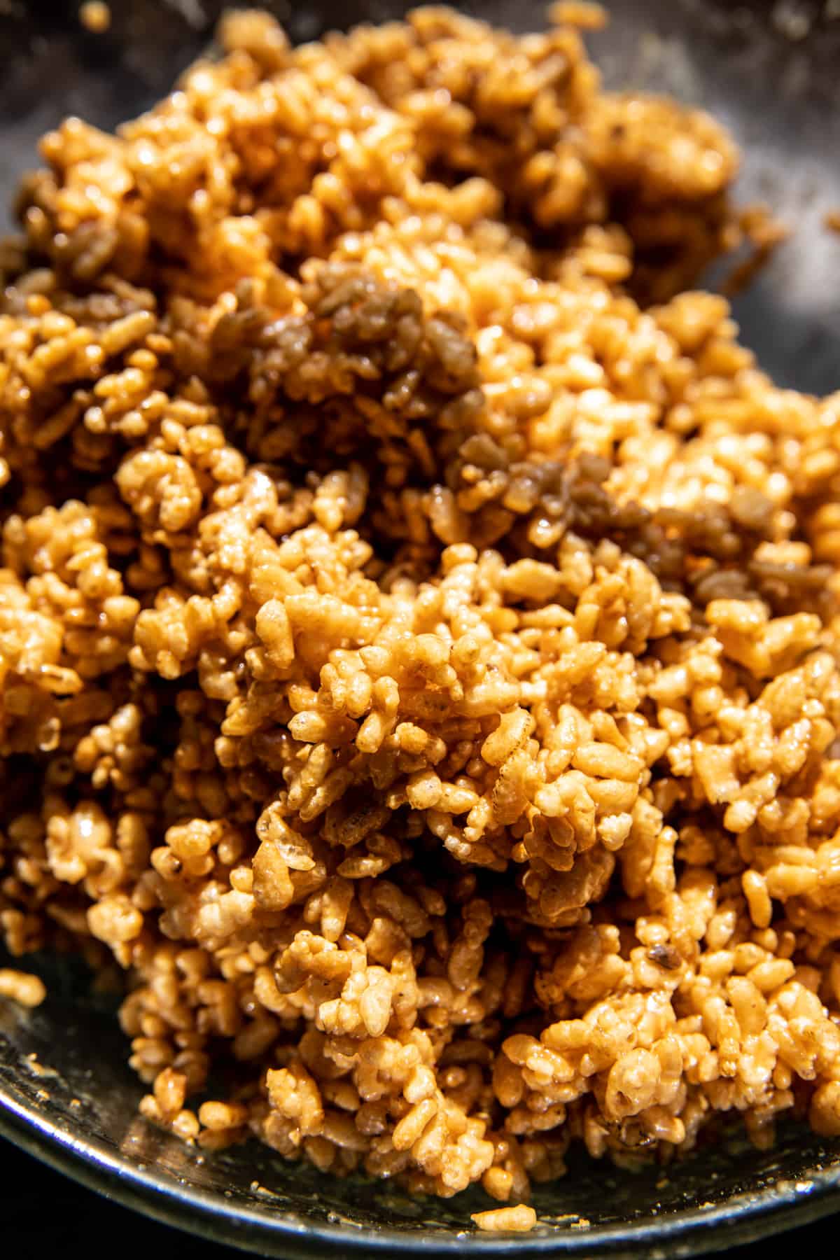 brown rice krispies mixed with peanut butter in bowl 