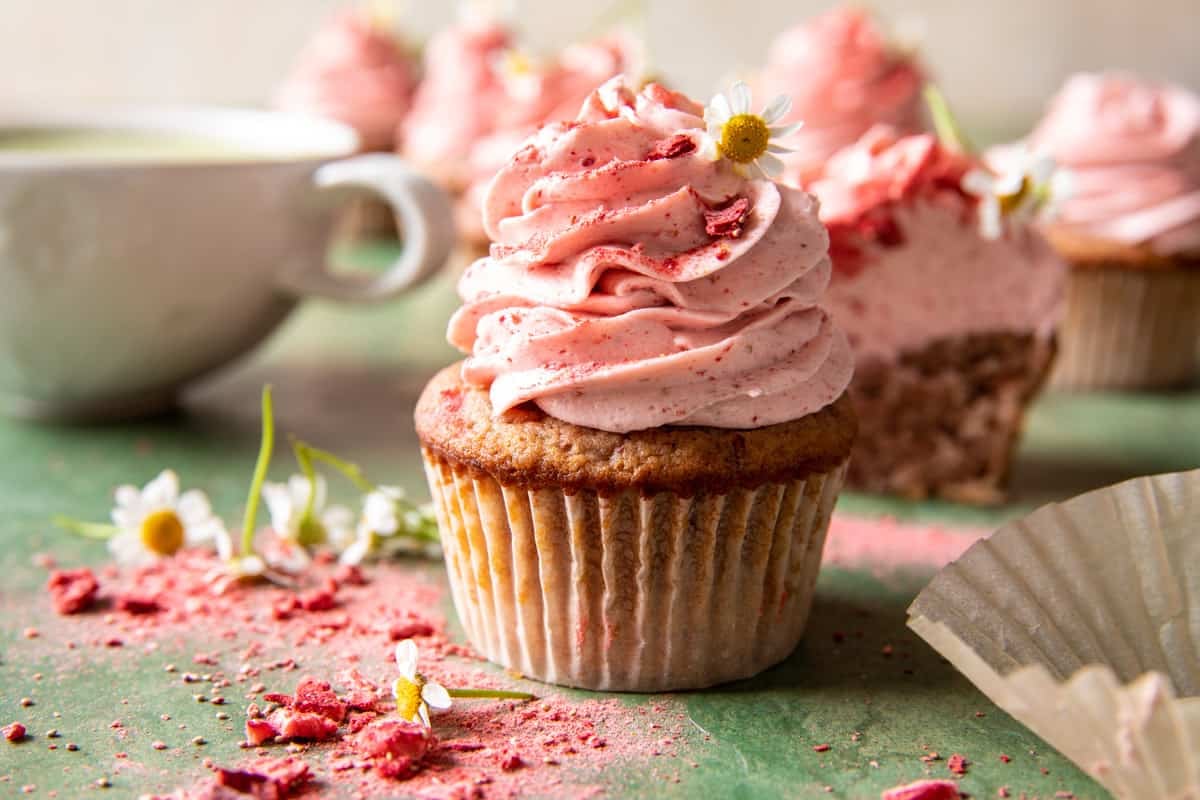 strawberry cupcake on table with mug 