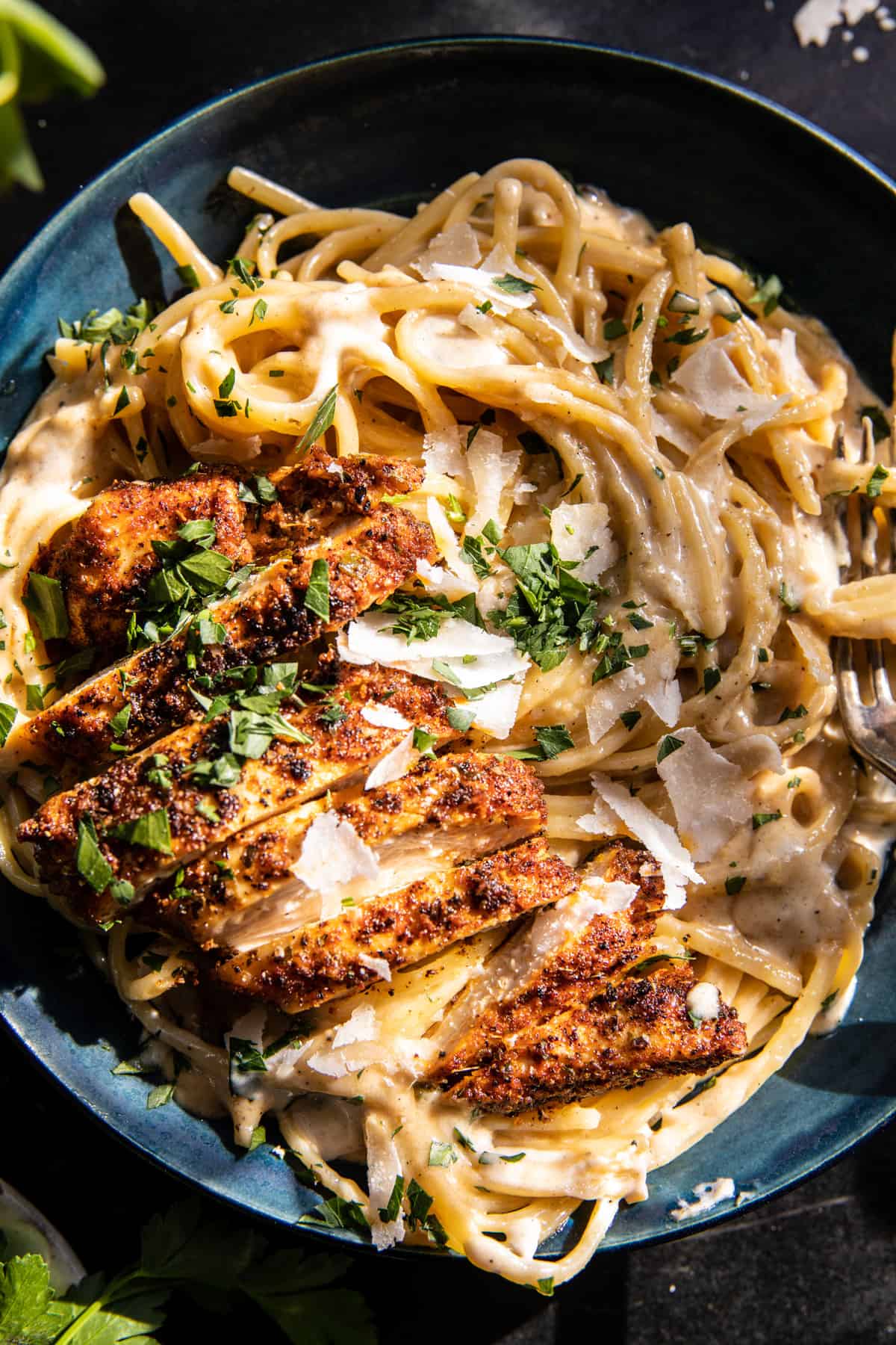 Cajun Chicken Fettuccine Alfredo in a pasta bowl with fork, very close up photo 