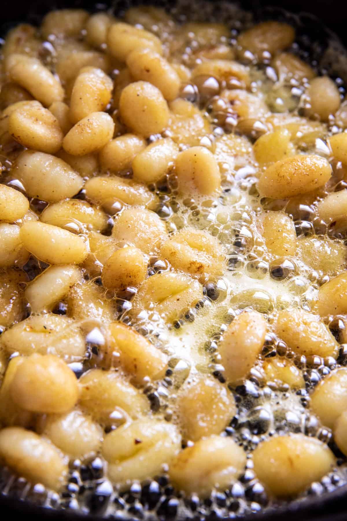 gnocchi cooking in skillet with butter