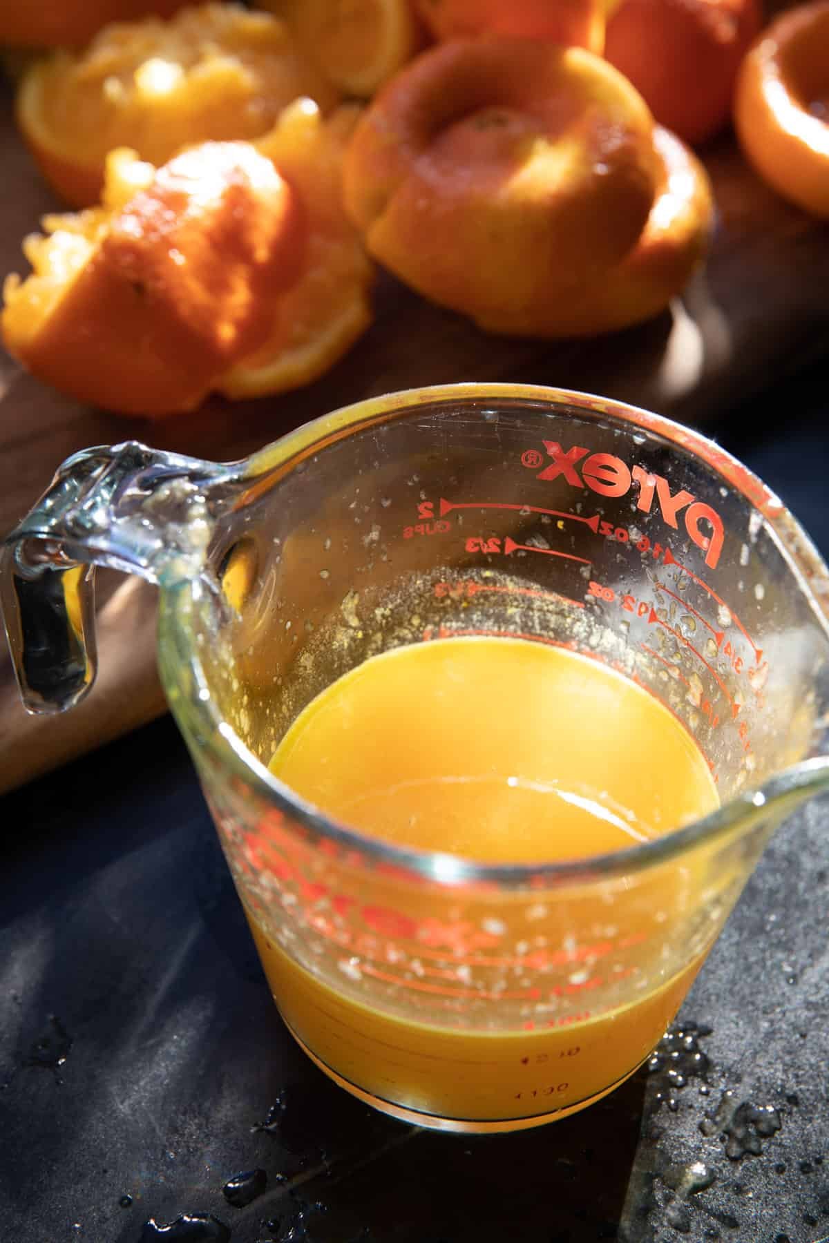 fresh orange juice in measuring cup