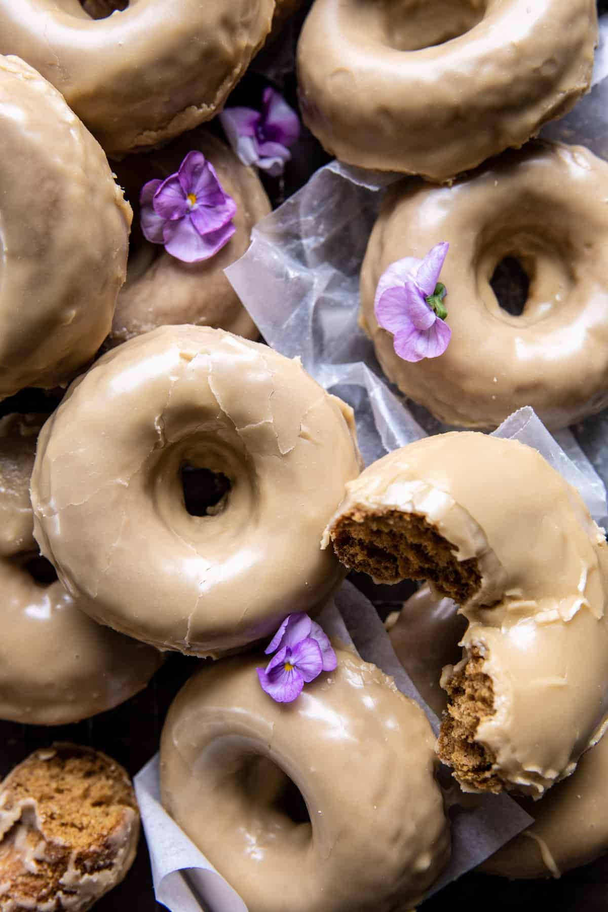over head photo of doughnuts with edible flowers